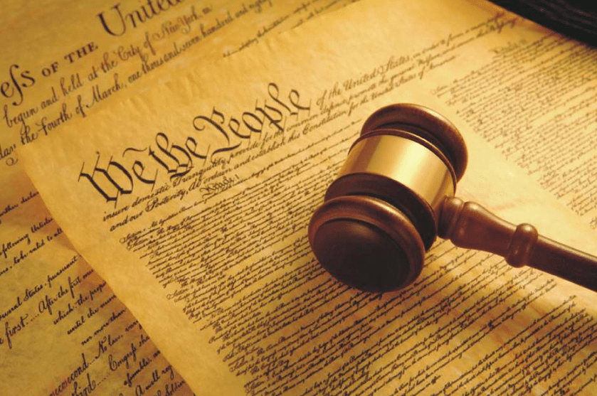 A judges gavel rests on a copy of the Preamble of the United States Constitution